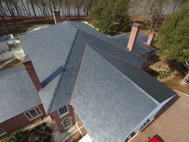 Natural slate roof with copper chimney flashing on a brick estate in South Georgia